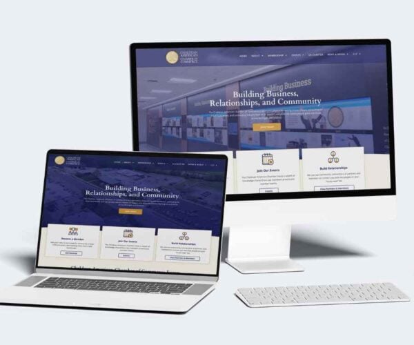 A desktop and laptop mockup displaying the custom-designed, responsive homepage of the Chaldean American Chamber of Commerce website.